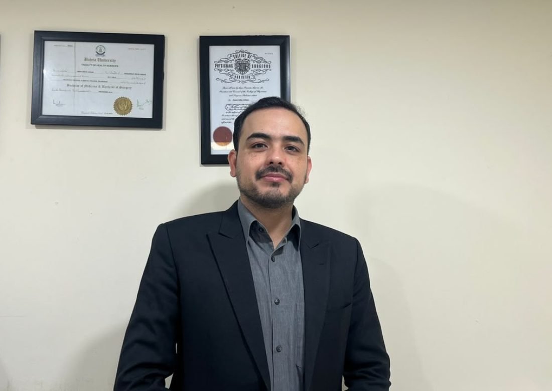 Dr. Muhammad Huzaifa at his Islamabad clinic, with his medical qualifications displayed